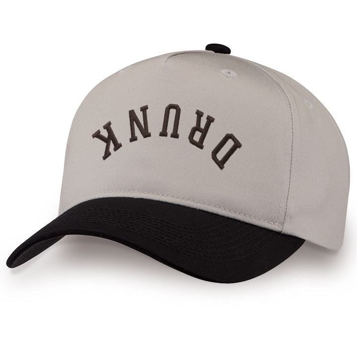 Black embroidered snapback hat with DRUNK stitched across the front