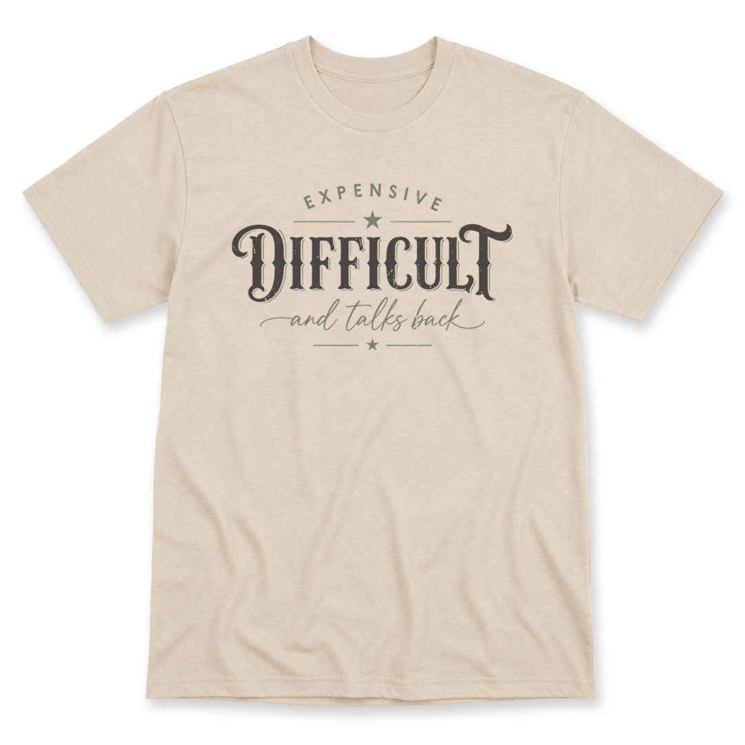 Sand t-shirt printed with the Expensive Difficult And Talks Back design, by Pinetree Innovations