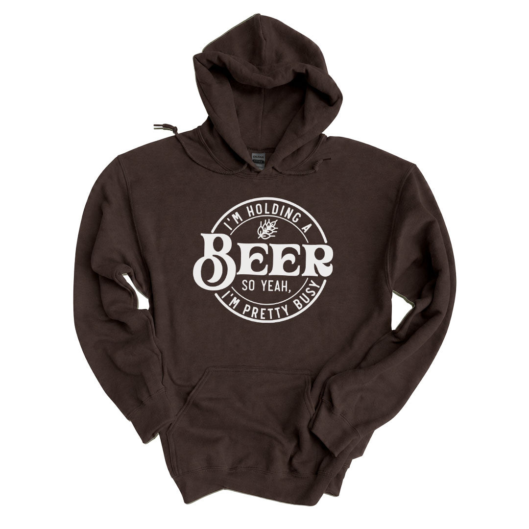 Dark Chocolate hoodie printed with the Im Holding A Beer design across the front