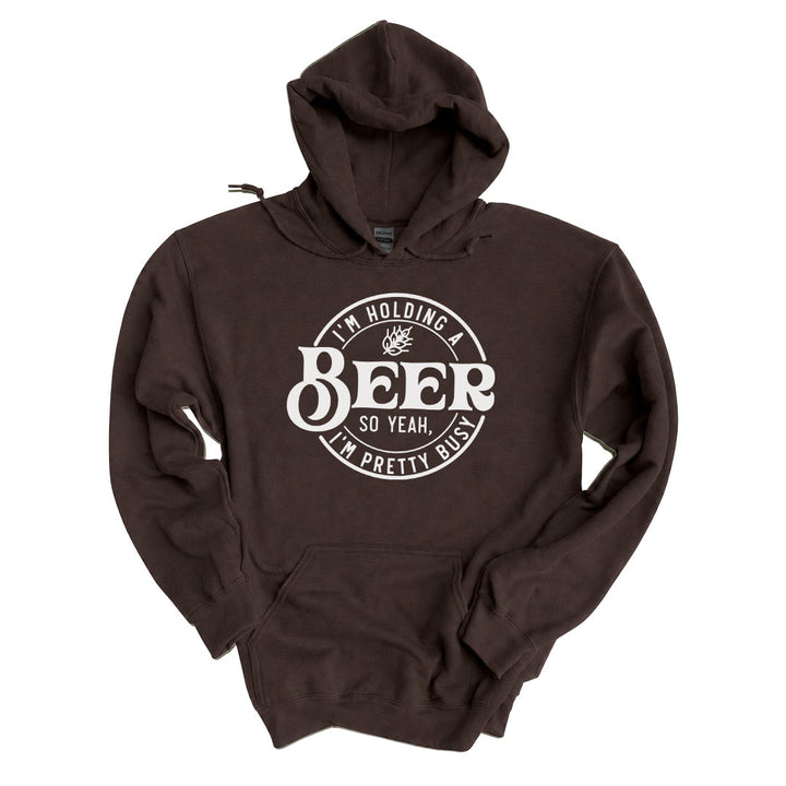 Dark Chocolate hoodie printed with the Im Holding A Beer design across the front