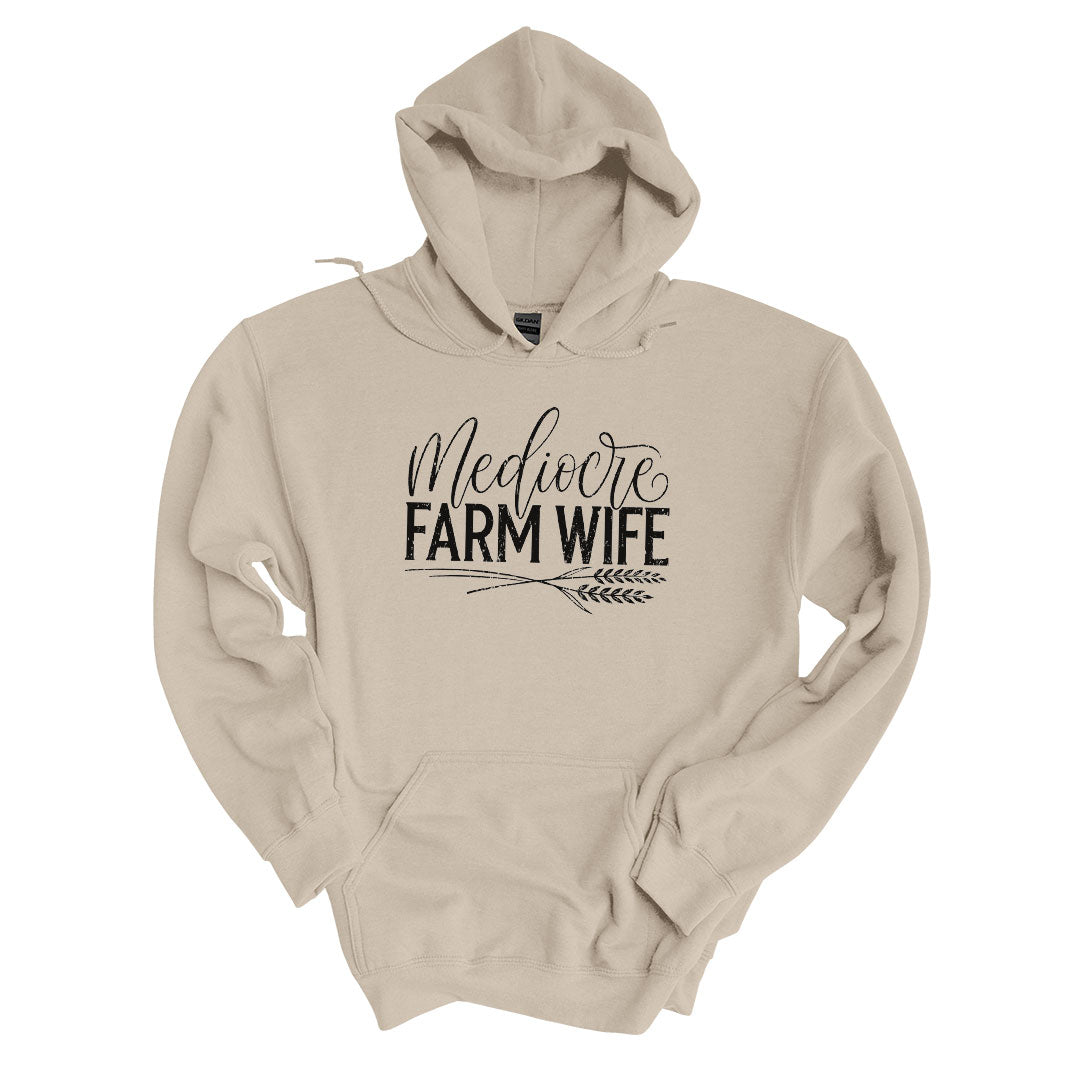 Sand hoodie with the Mediocre Farm Wife design printed across the front