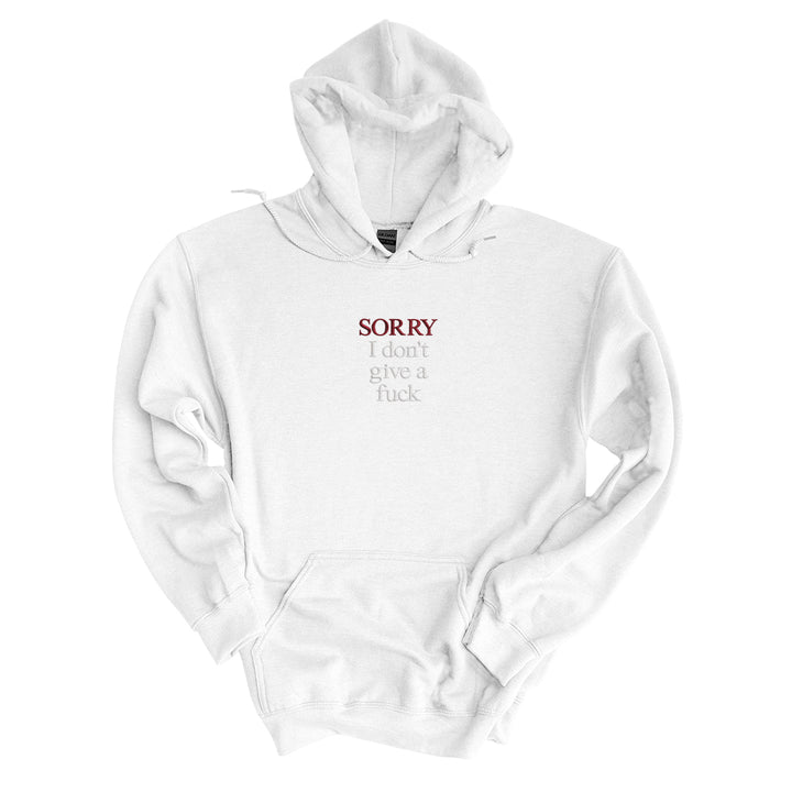 White hoodie embroidered with Sorry in black thread and I don&