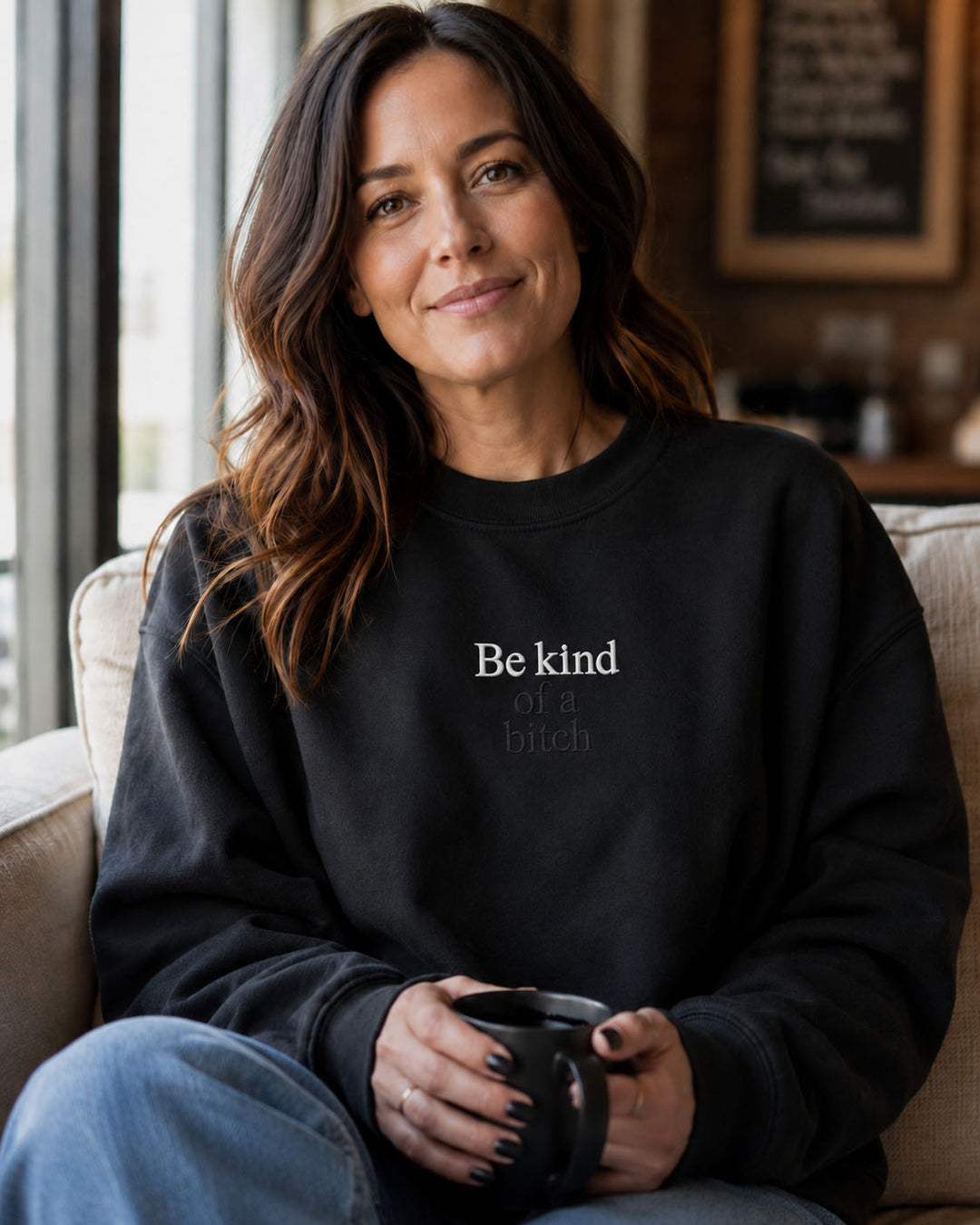 Close-up of Be kind of a bitch embroidery on a Properly Improper crewneck sweatshirt