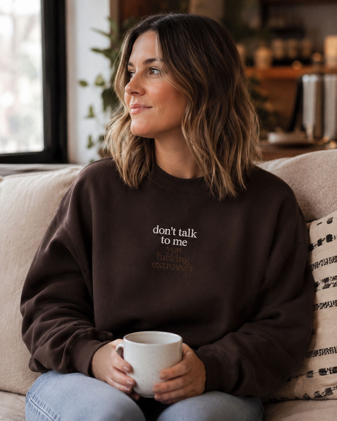 Close-up of Don't talk to me you fucking extrovert embroidery on a Properly Improper crewneck sweatshirt