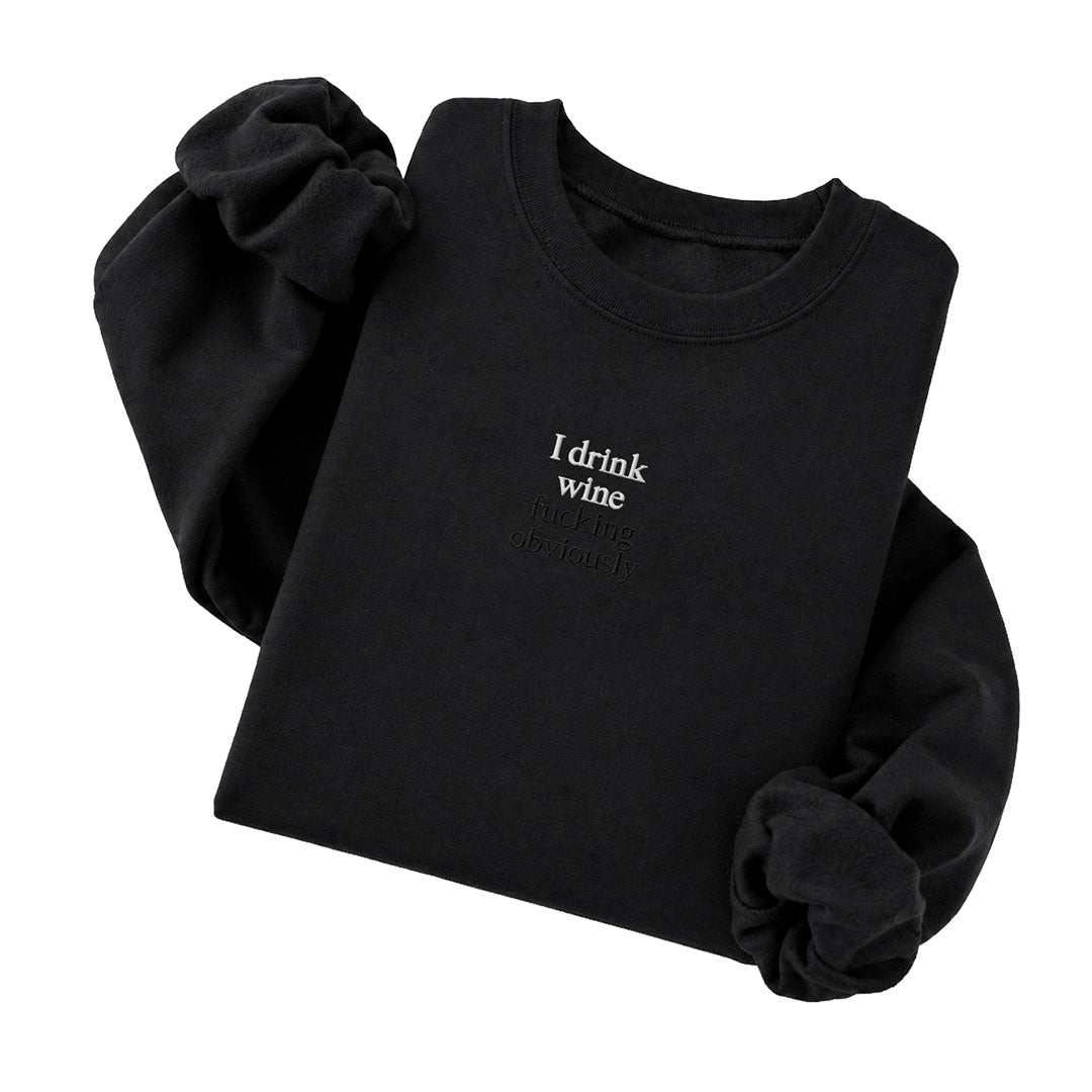 Black crewneck sweatshirt embroidered with I drink wine in white thread and fucking obviously in tonal thread below