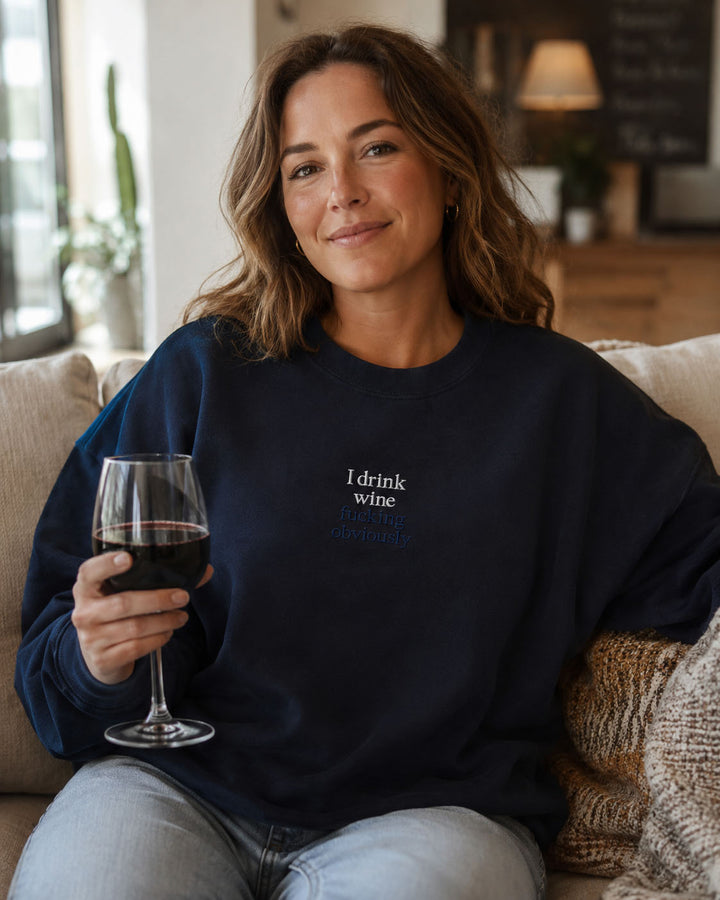Close-up of I drink wine fucking obviously embroidery on a Properly Improper crewneck sweatshirt
