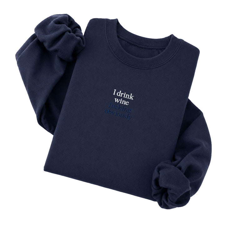 Navy crewneck sweatshirt embroidered with I drink wine in white thread and fucking obviously in tonal thread below