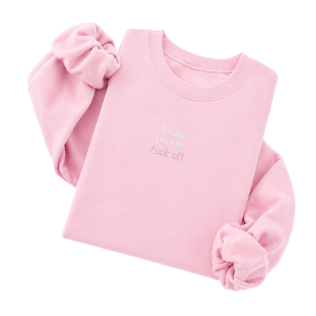Light Pink crewneck sweatshirt embroidered with I hate people in white thread and fuck off in tonal thread below