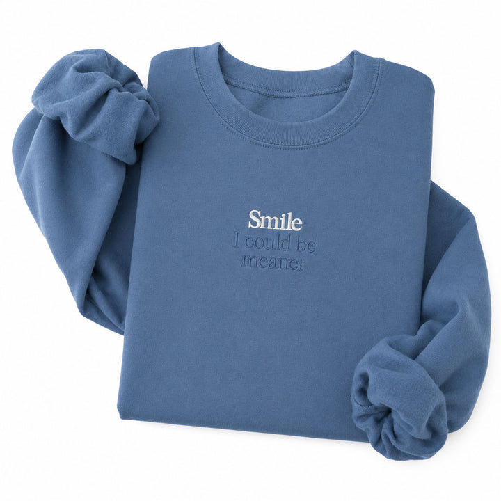 Indigo Blue crewneck sweatshirt embroidered with Smile in white thread and I could be meaner in tonal thread below
