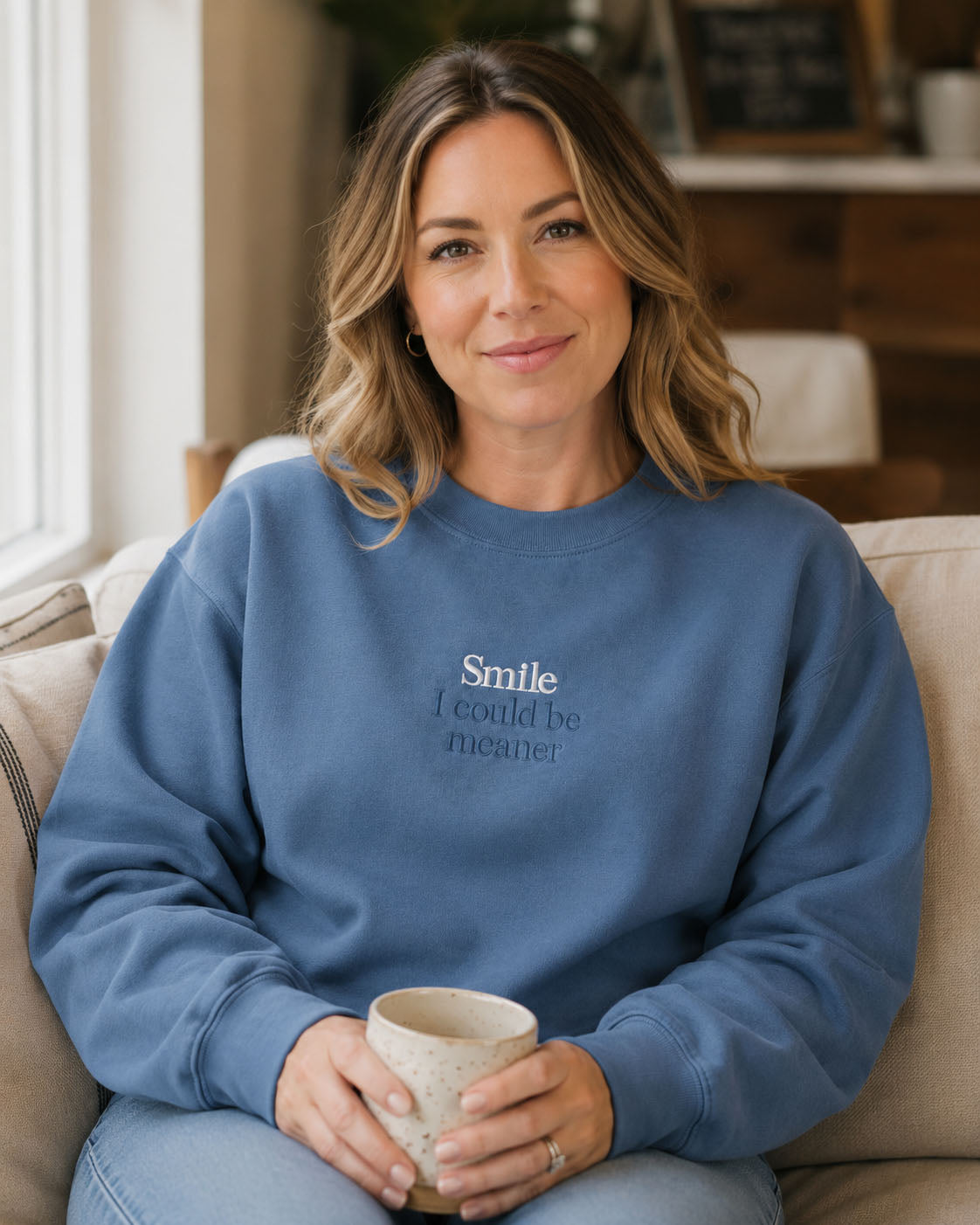 Close-up of Smile I could be meaner embroidery on a Properly Improper crewneck sweatshirt
