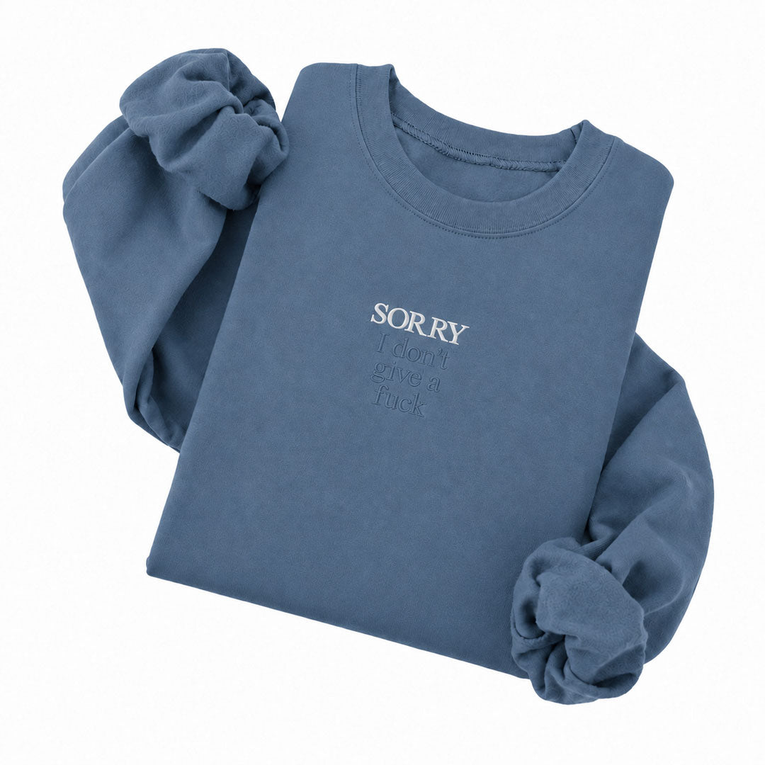 Indigo Blue crewneck sweatshirt embroidered with Sorry in white thread and I don&