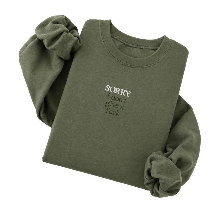 Military Green crewneck sweatshirt embroidered with Sorry in white thread and I don&