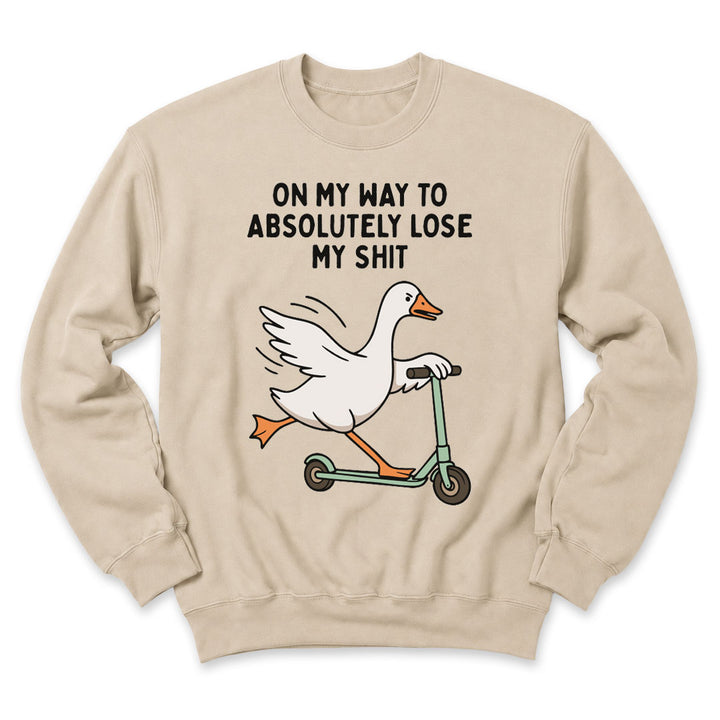 Sand crewneck sweatshirt printed with "On My Way To Absolutely Lose My Shit" across the front