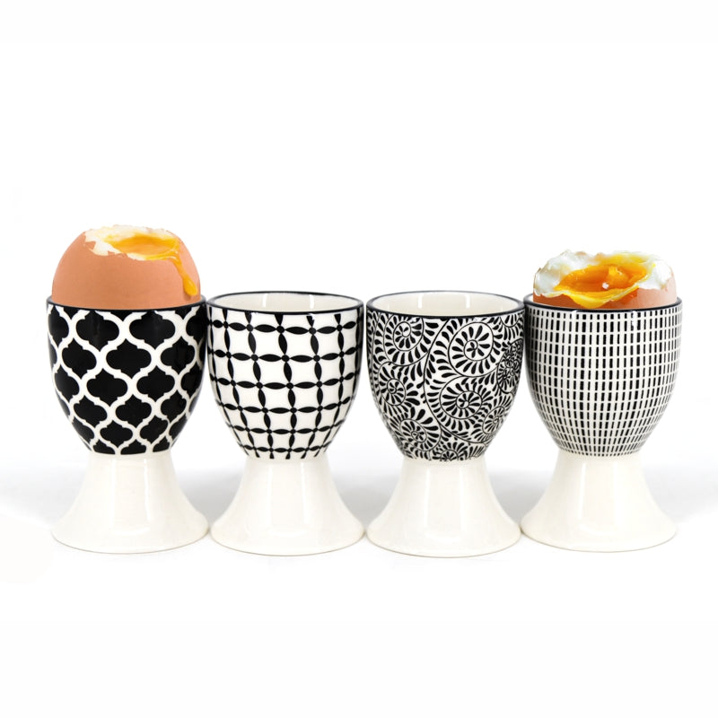 Set of four black and white patterned porcelain egg cups