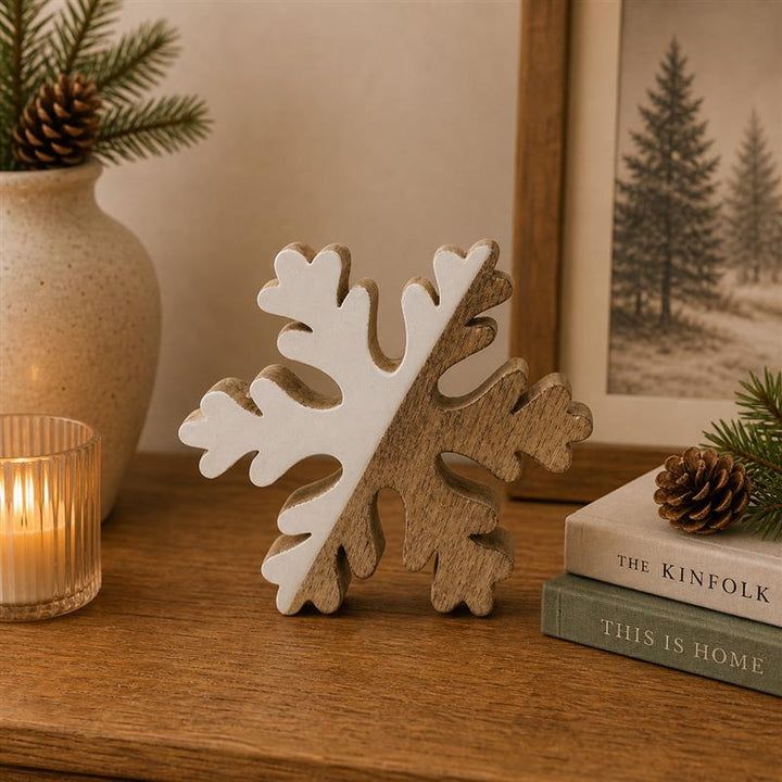 Wood and enamel snowflake on a shelf