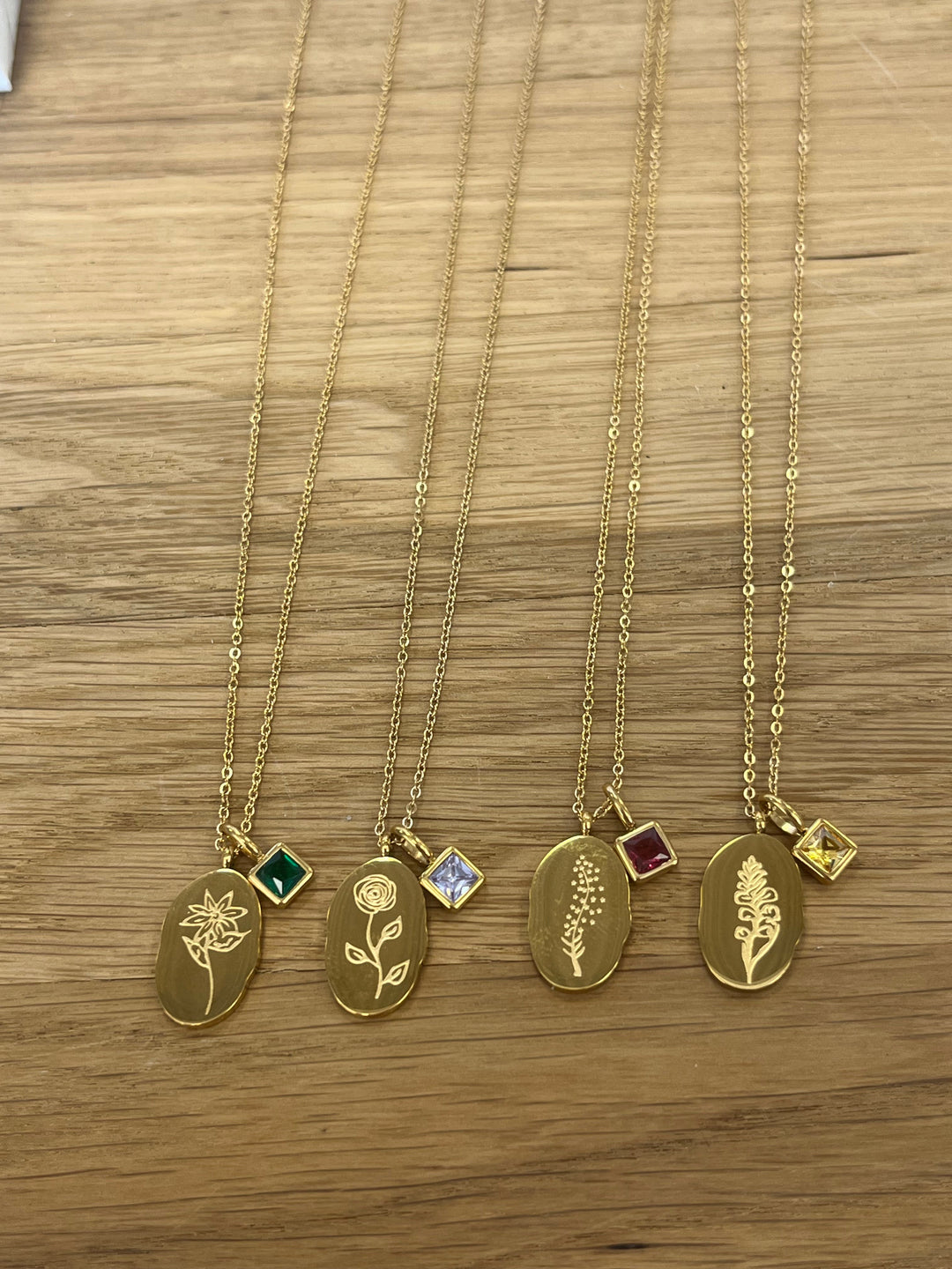 Gold birth month flower necklaces with birthstone charms