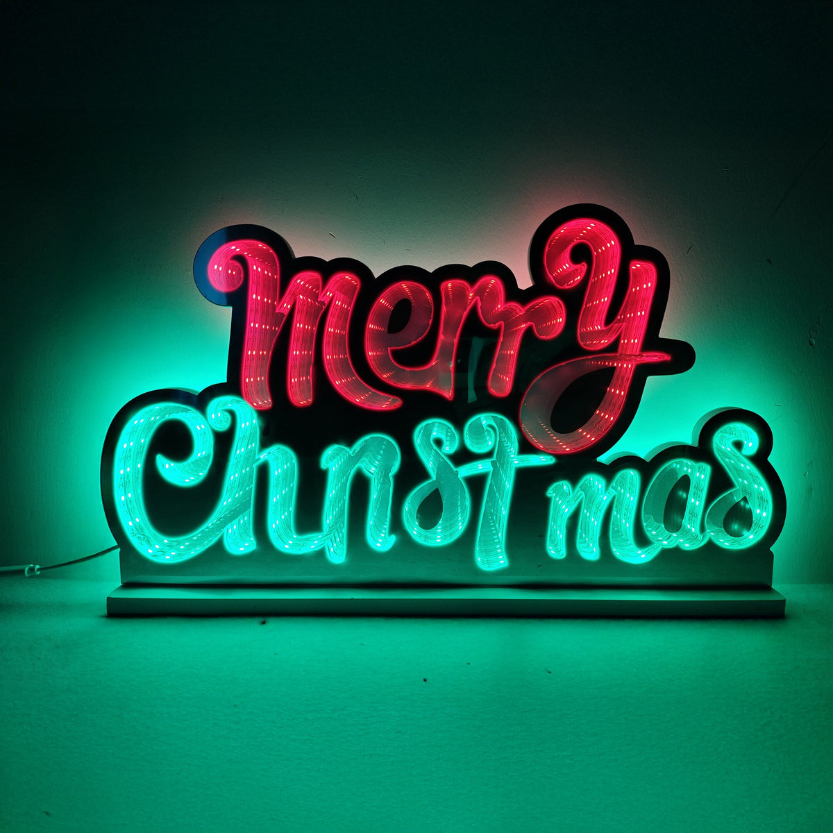LED infinity mirror Merry Christmas sign in red and green lettering