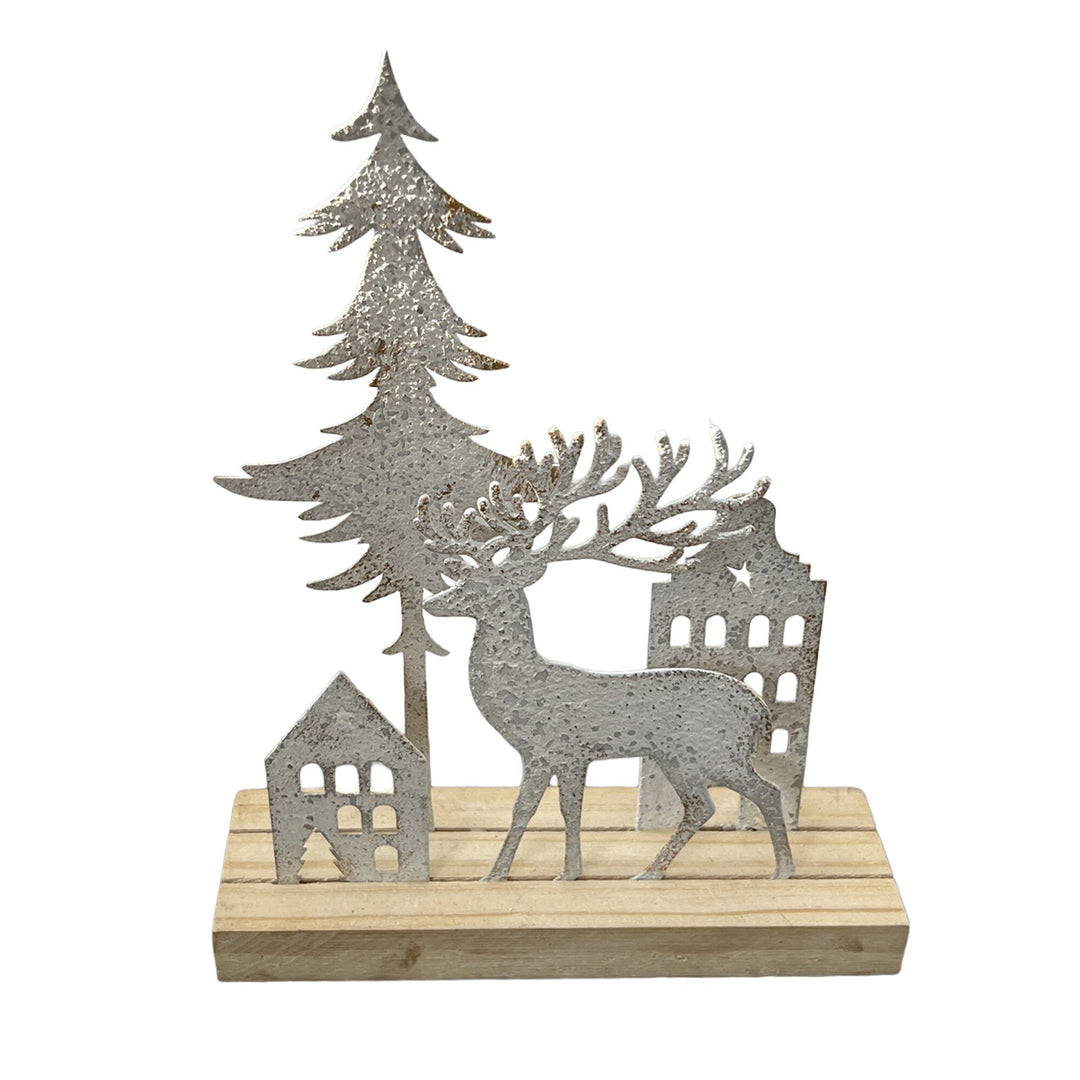 Antique white-washed metal reindeer with pine tree and house scene on a base